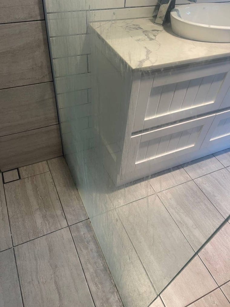 Shower screen before cleaning, soap scum build-up